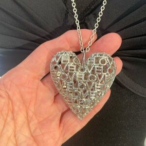 XL 17” puffed heart with filigree LOVE continuous on both sides.  Silver tone
